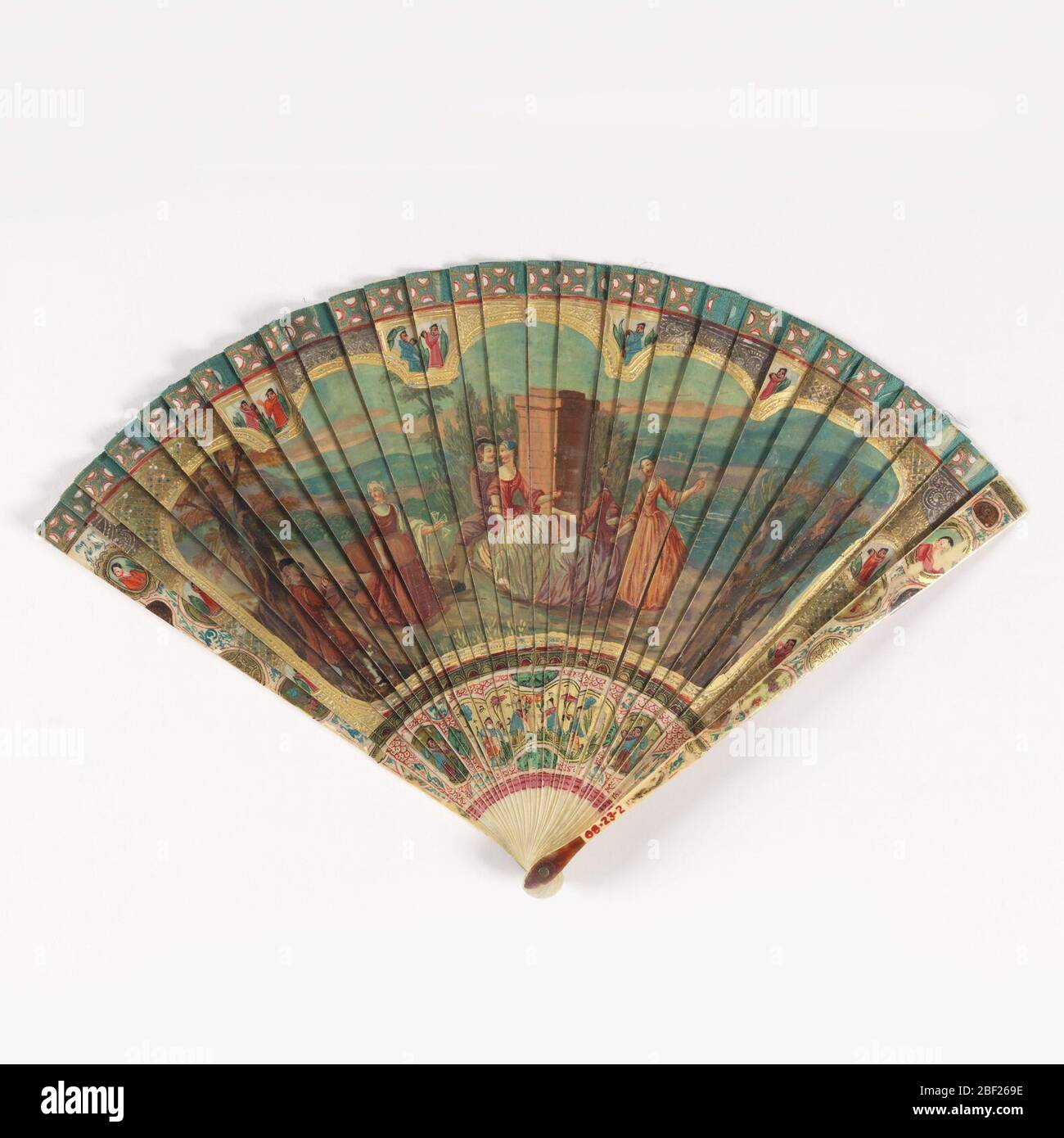 Bris fan. Fan with observe painted with a design of dancers and musicians against a landscape background. Reverse has a landscape scene with trees against a hilly backdrop. In margins are birds and figures in a chinoiserie style. Stock Photo