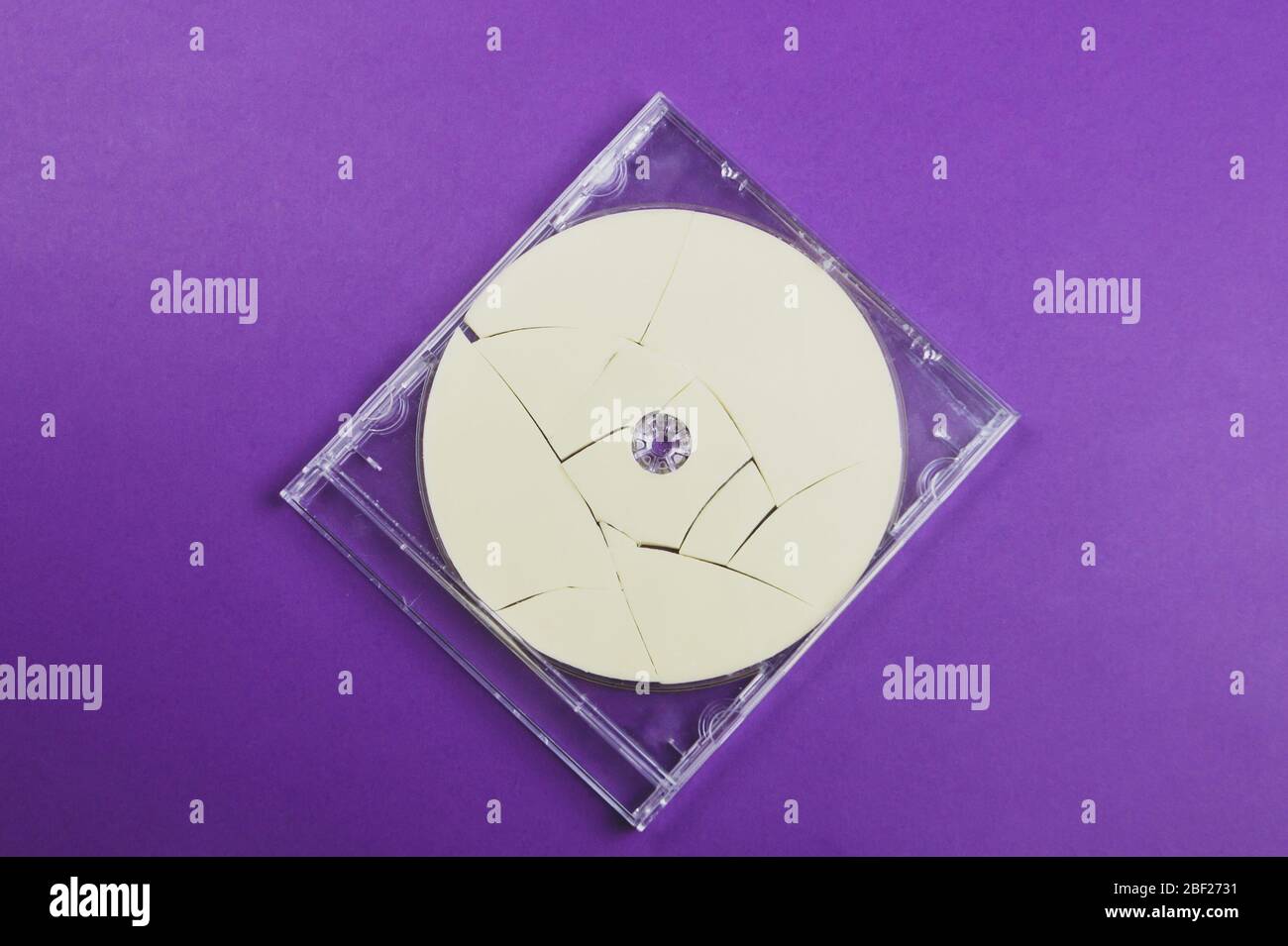Broken disc in a box on a colored background Stock Photo