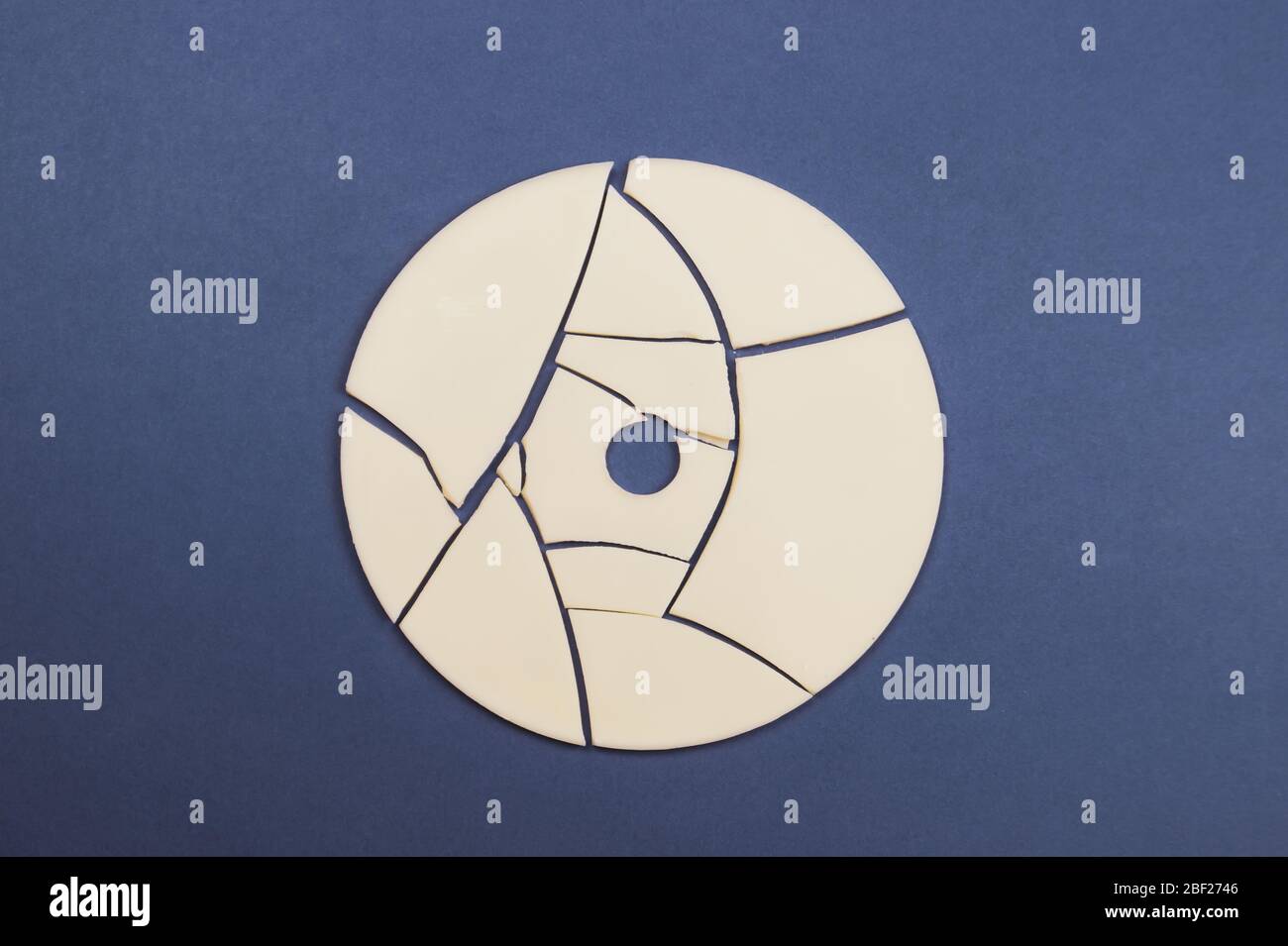 Cracked disc on color background Stock Photo