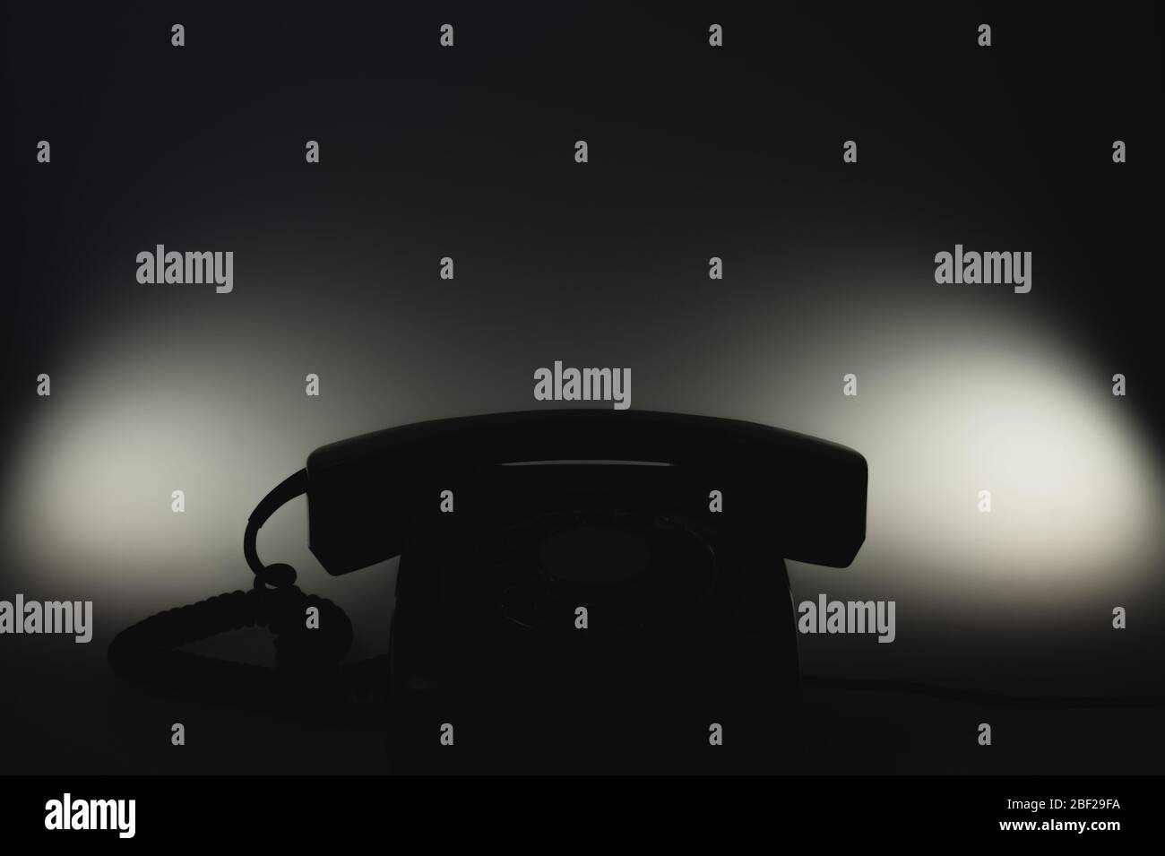 Classic phone silhouette in the dark. telephone with phone receiver. office background. old communication technology Stock Photo