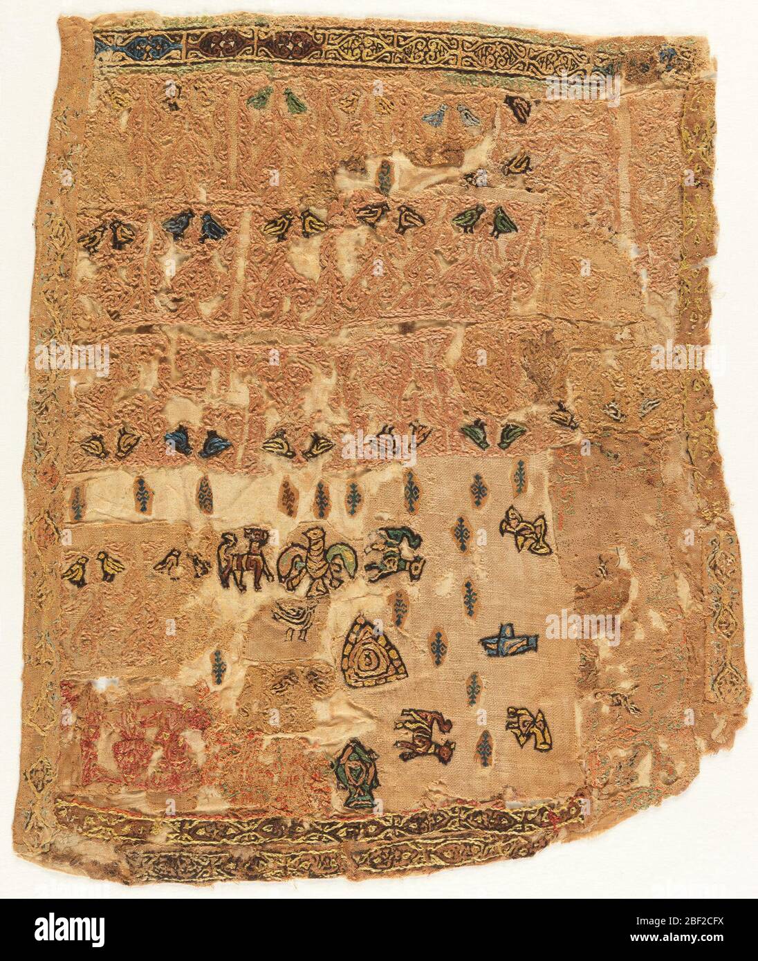 Fragment. Early Islamic embroidery fragment. Silk on linen showing multicolored fish, pairs of birds and other animals embroidered with dark outline. Allover designs of scrolls and palmettes. Scattered geometric ornament in blue. Stock Photo