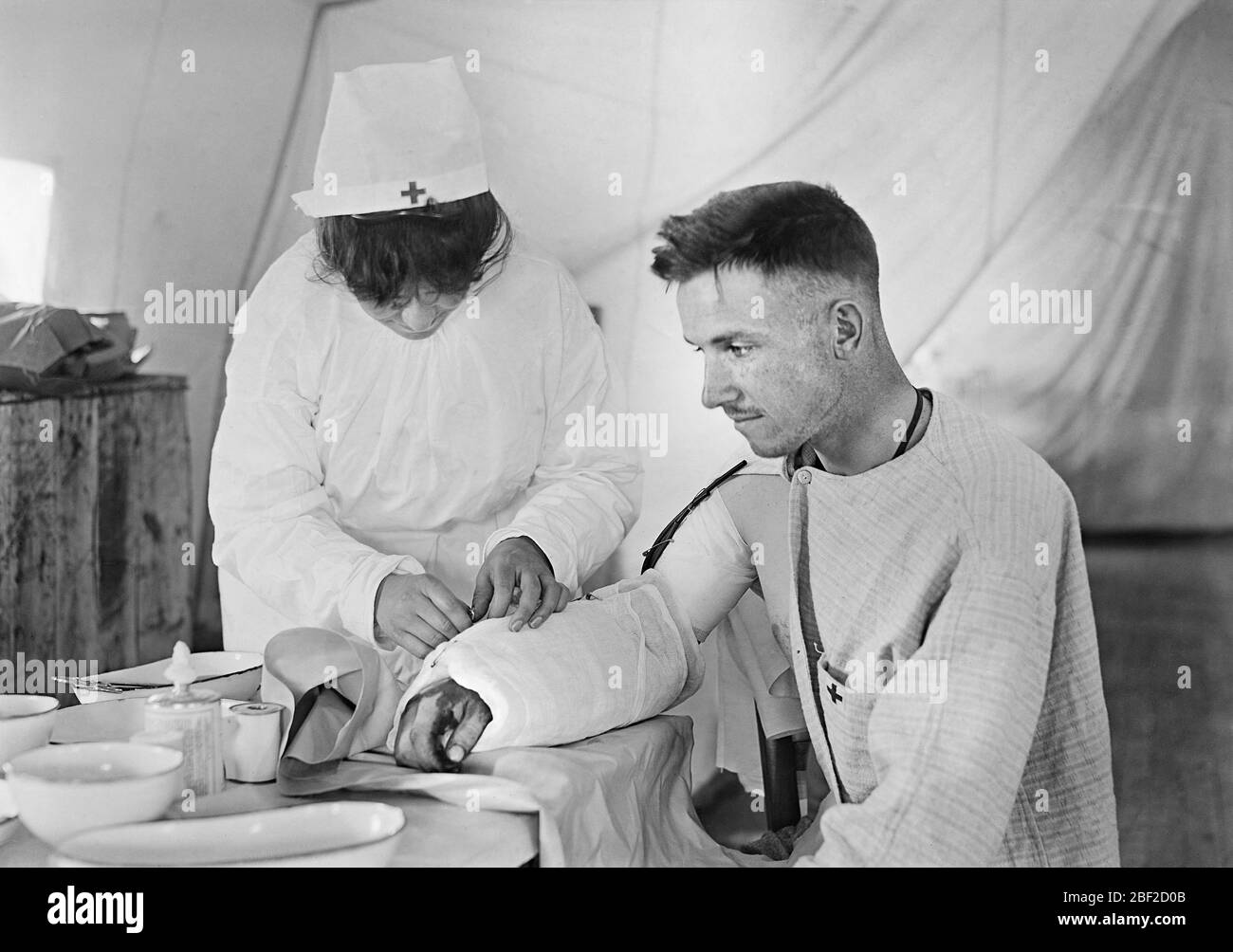 American Red Cross Nurse bandaging arm of Wounded American Soldier, American Military Hospital No. 5, a complete portable Tent Hospital supported by American Red Cross, Auteuil, France, Lewis Wickes Hine, American National Red Cross Photograph Collection, June 1918 Stock Photo