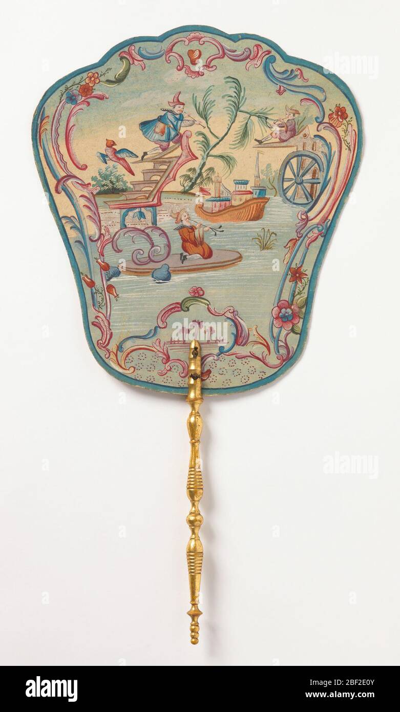 Handscreen. Obverse: a fanciful Chinoiserie river scene with three musicians perched on different architectural follies, enclosed by c-scroll border. Reverse: painted flower and three printed verses pasted on to back. Turned and gilded wood handle. Stock Photo