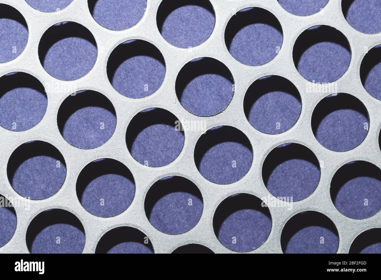 Steel plate with holes. metal grid with round cells. modern background