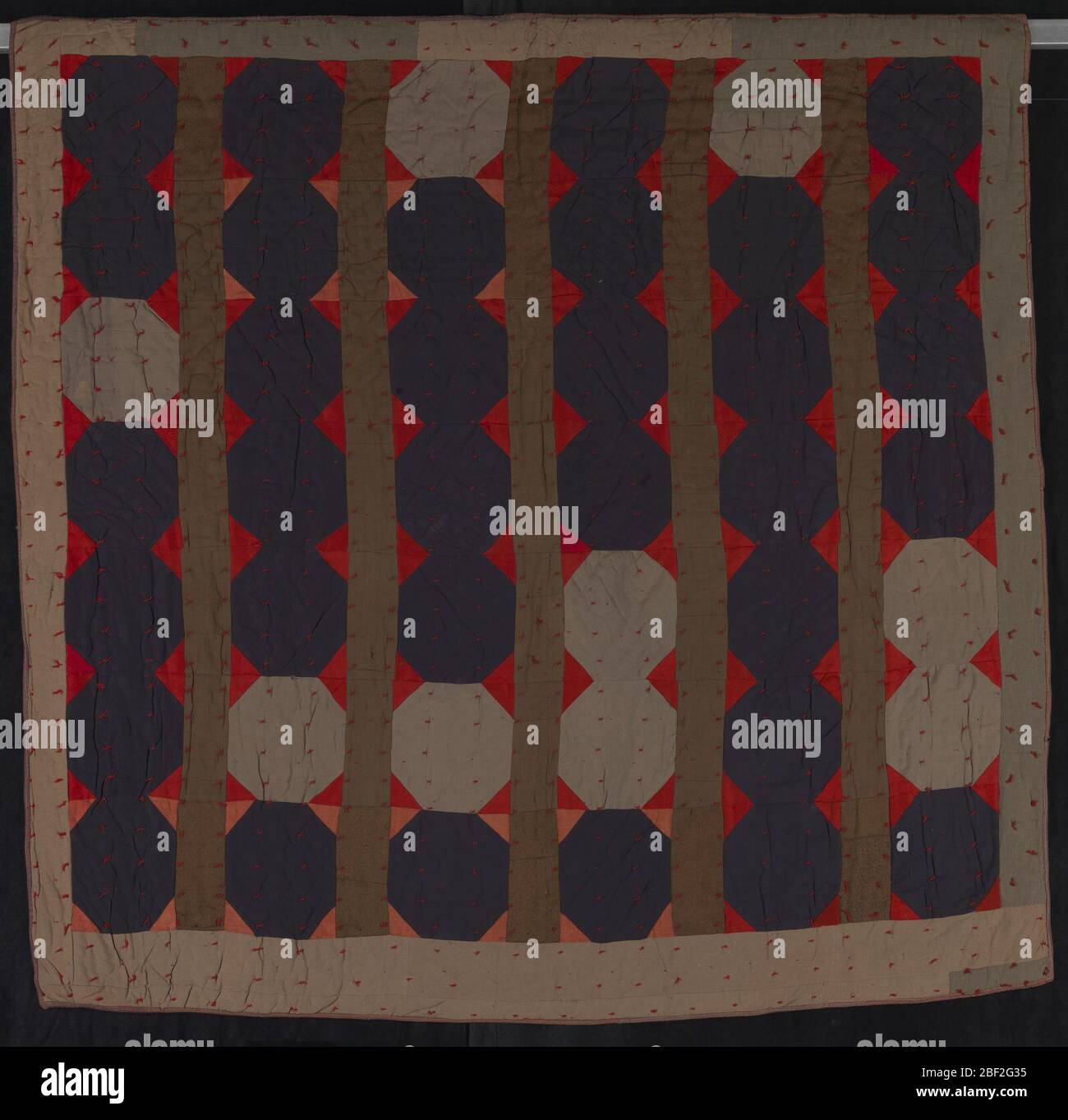 Untitled Octagons and Bars. Improvisational quilts, or those with free-form patterns, are an old, ongoing tradition in African American quilting. They represent a practical need for warmth, but, in the early and mid-twentieth century, they also provided a rare splash of color in drab dwellings. Stock Photo