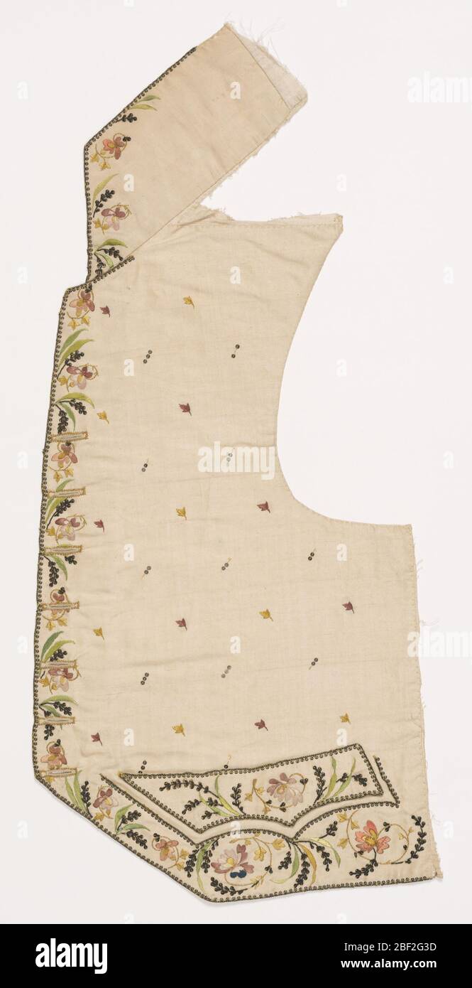 Waistcoat. Left front of man's waistcoat in cream-colored silk with multicolored floral embroidery down the front and along the bottom. In a cutaway style with wide standup collar and pointed pocket flaps. Stock Photo