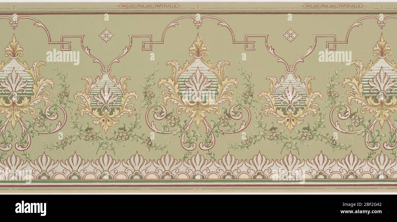 Frieze. Alternating large and small foliate medallions. The small medallion connects to an undulating line which breaks into a key pattern and has accents of acanthus leaves. A series of large flowers runs across the bottom. Printed in white and shades of green. Stock Photo