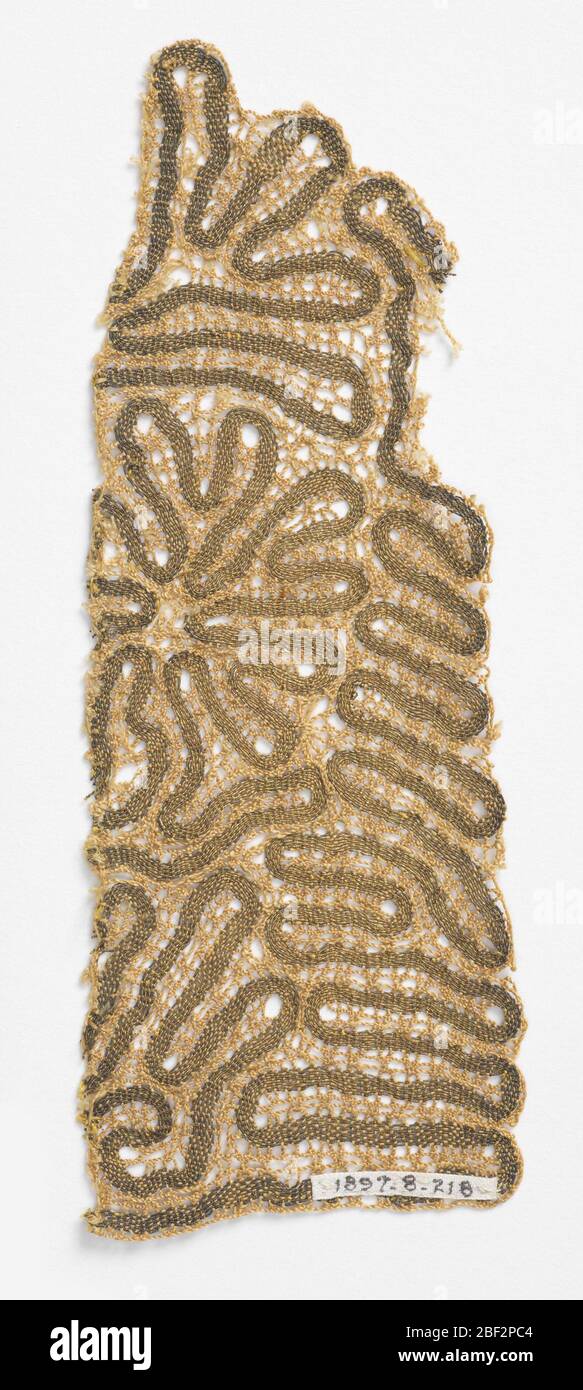 Fragment. Wavy, ribbon-like design in gold colored metallic thread and ...