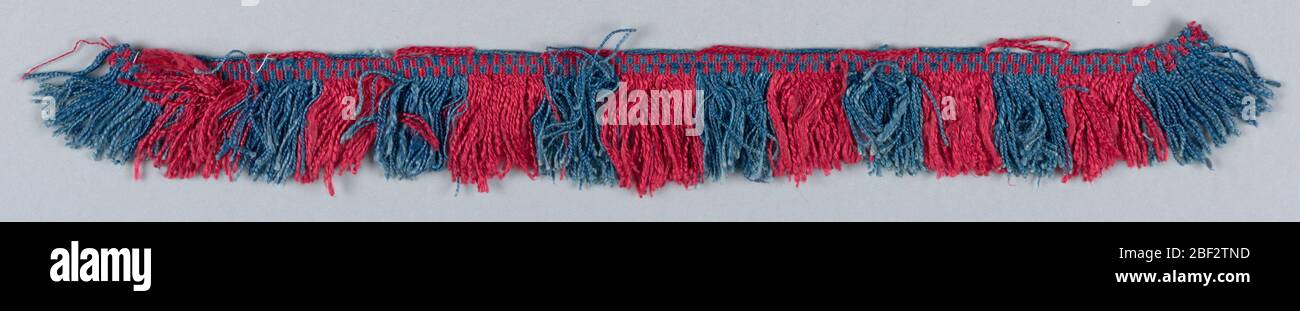 Fringe. Fringe with a red and blue checkerboard heading. Red and blue skirt threads arranged to form stripes. Stock Photo