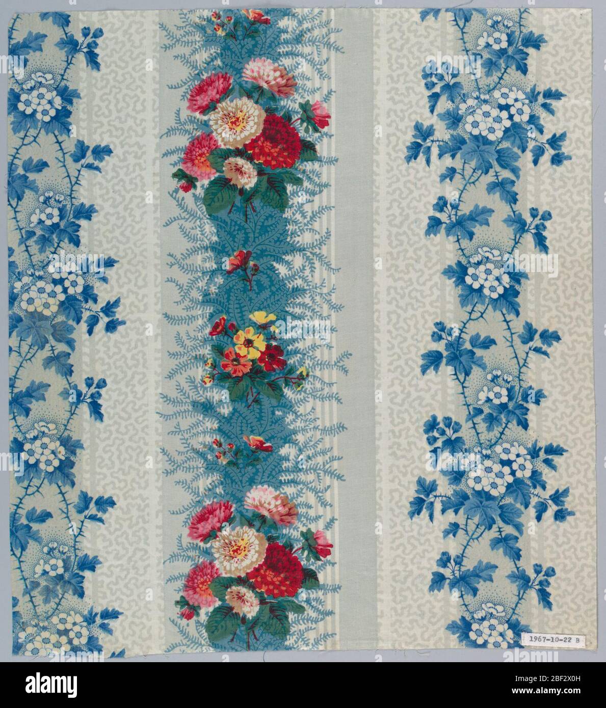 Textile. Sample in similar pattern to A with grey striped ground, vermicular pattern in grey, blue vine and white flowers, and stripe over-printed with close clusters of pink and red carnations, and smaller flower, rgeen foliage. Stock Photo