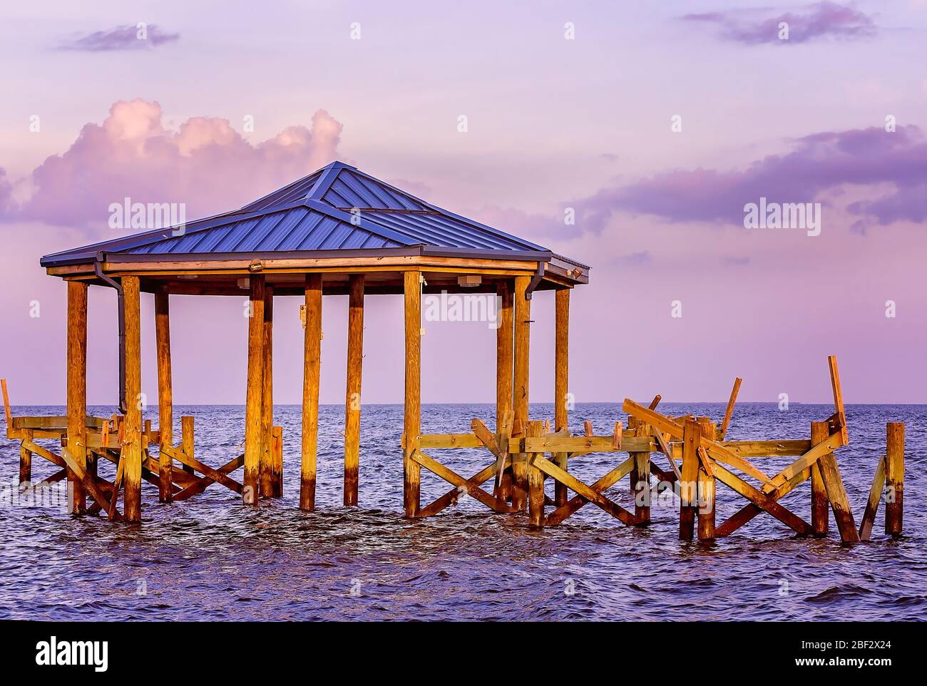A pier, damaged by Hurricane Katrina in 2005, remains broken, June 27, 2013, in Pass Christian, Mississippi. Stock Photo