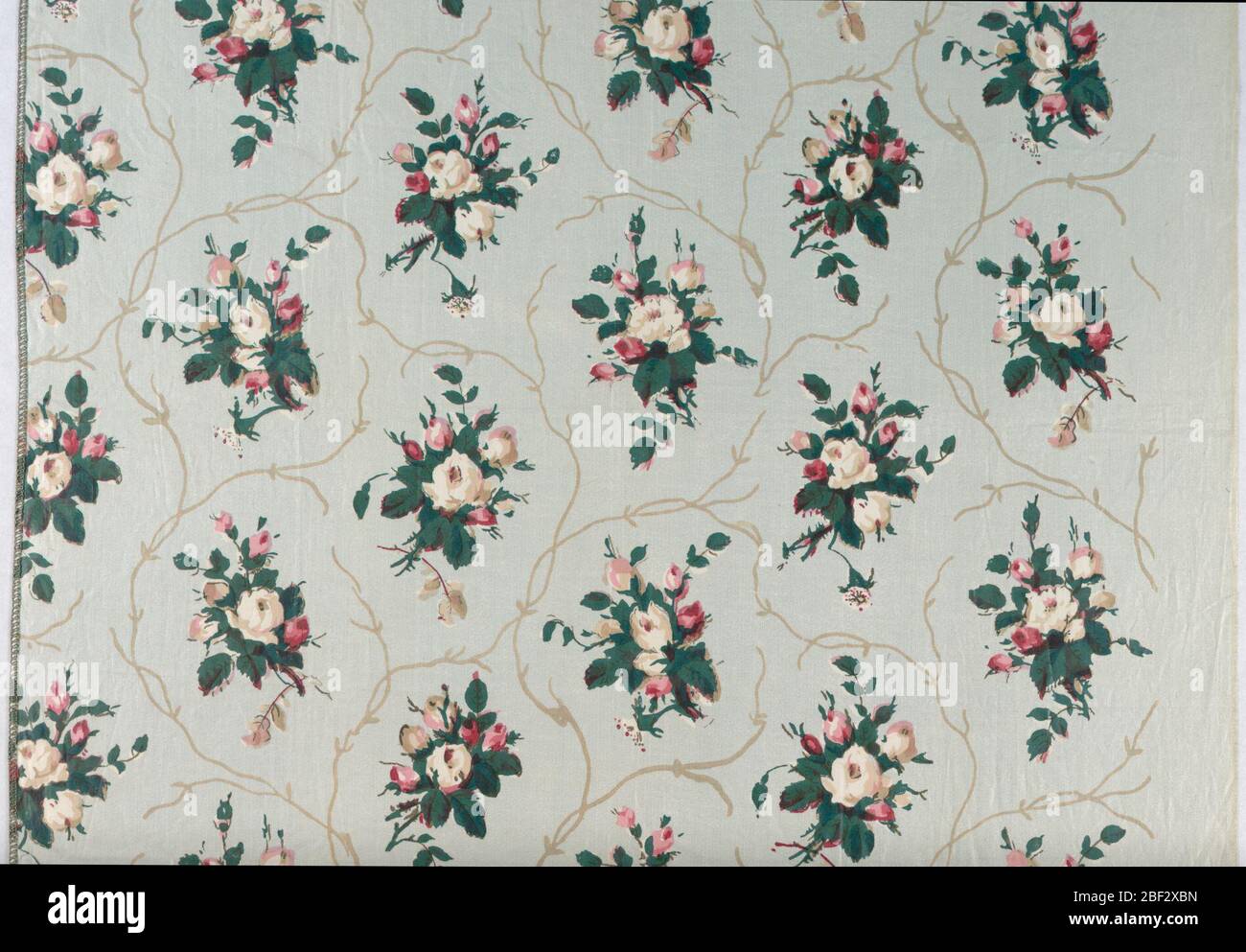 Textile. Allover design of floral sprays in red, green and tan on light blue background. Stock Photo