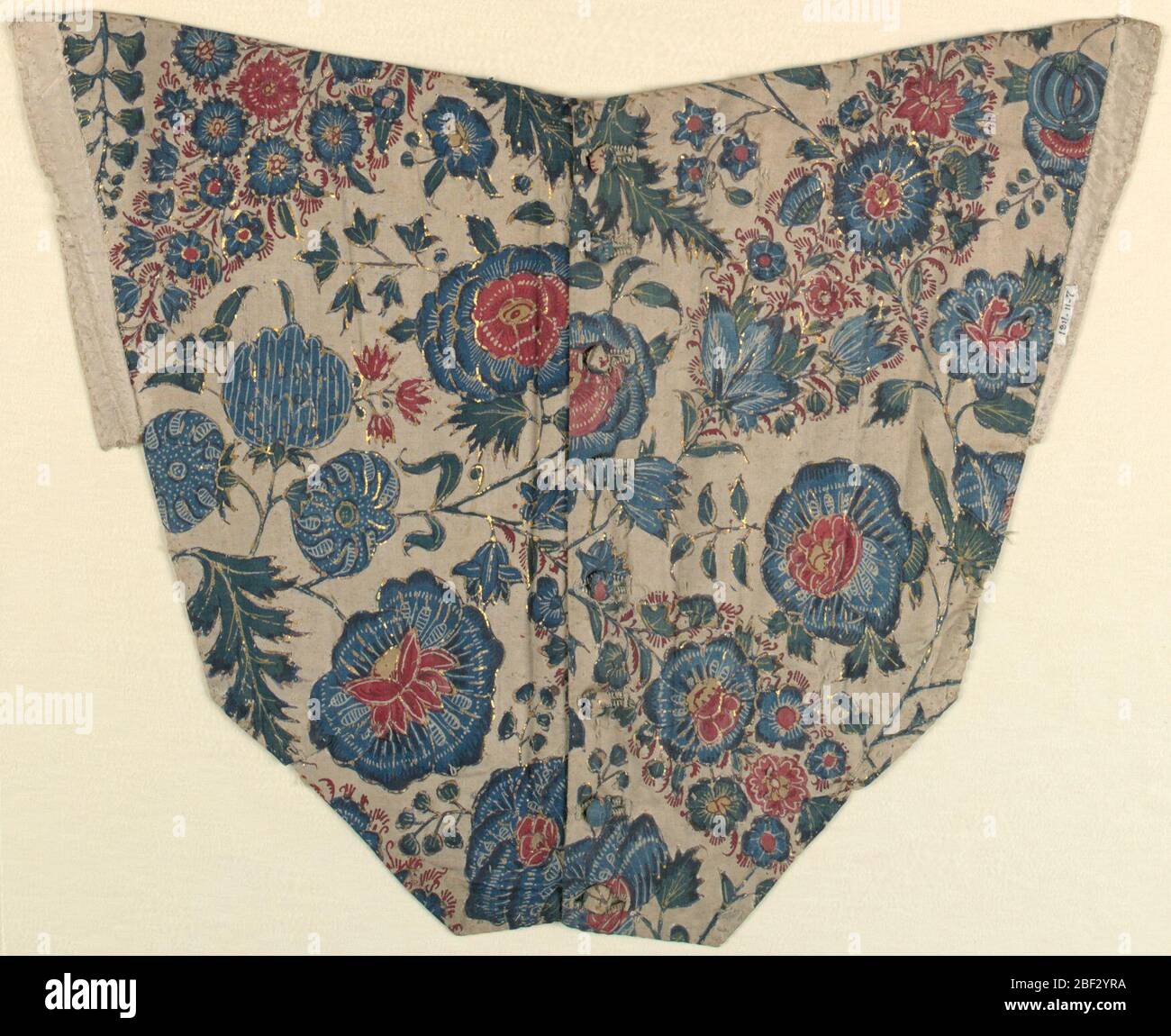 Bodice panel. Roughly v-shaped front panel of bodice of fine white cotton cloth with painted and dyed design of variously decorated flower heads, pointed clusters of flowerets, and various leaf forms, on freely twining stems; in blue, red, green, yellow, with much reserved Stock Photo