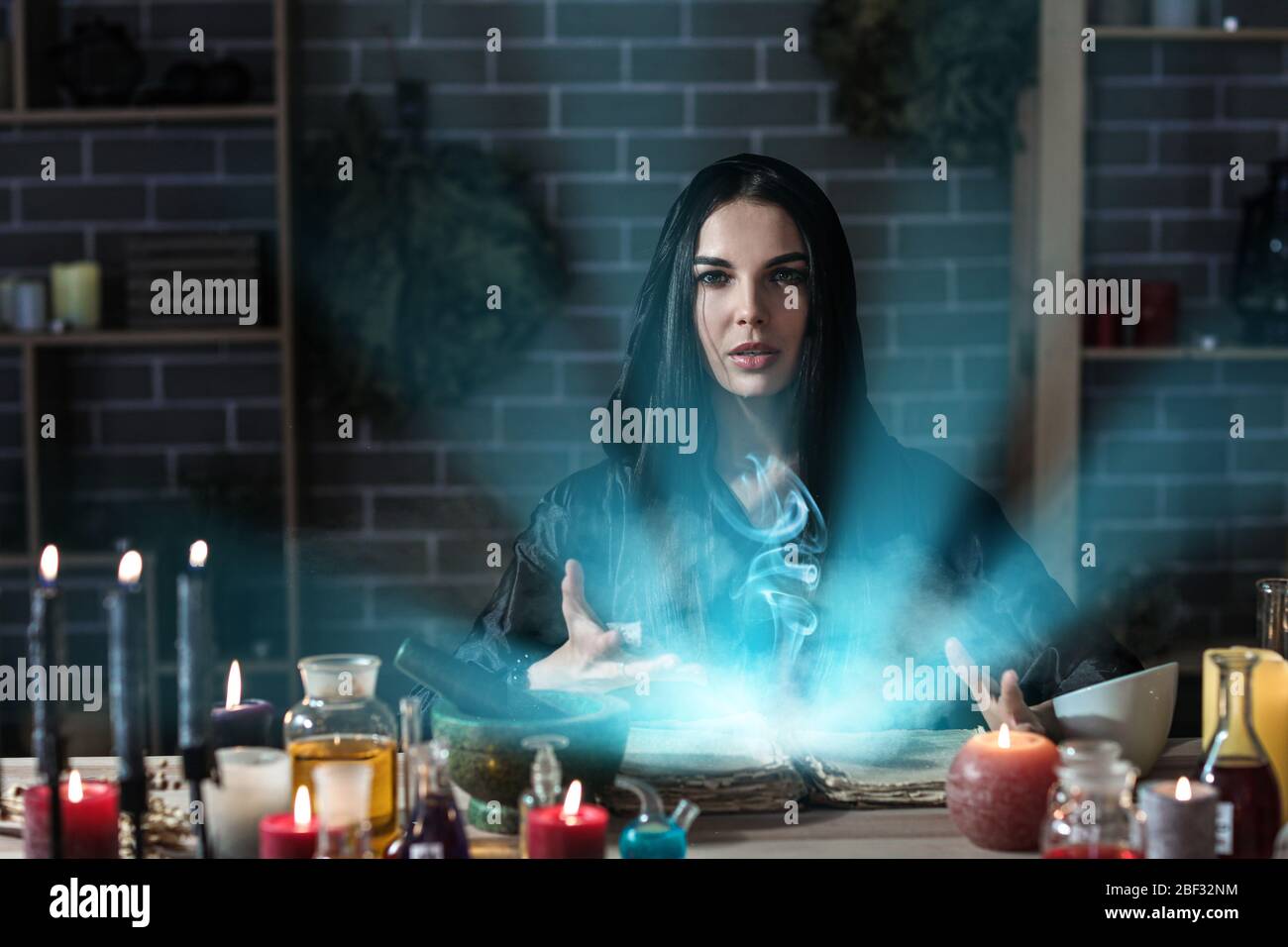 Female alchemist making elixir in laboratory Stock Photo