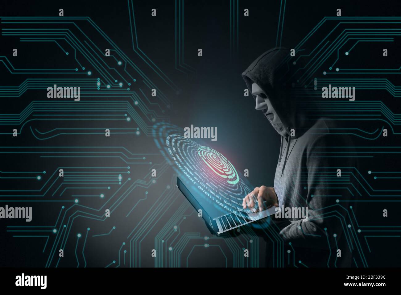 Professional hacker with laptop on dark background Stock Photo