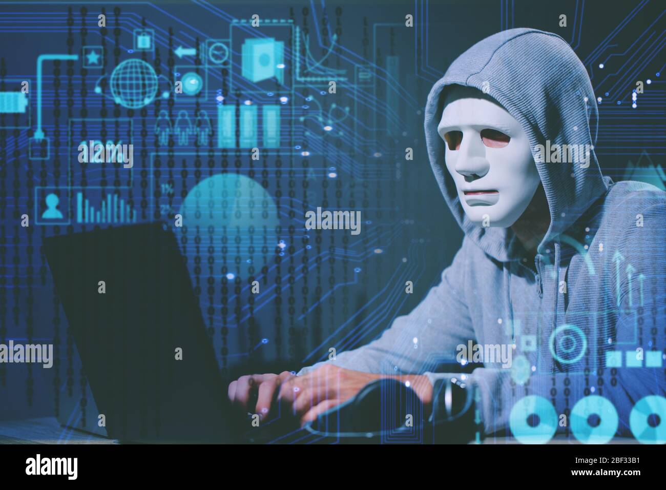 Professional hacker using laptop in dark room Stock Photo