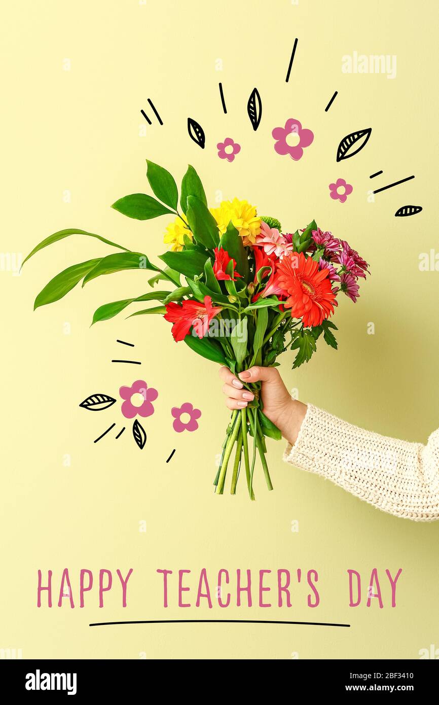 Female hand with beautiful bouquet of flowers and text HAPPY ...