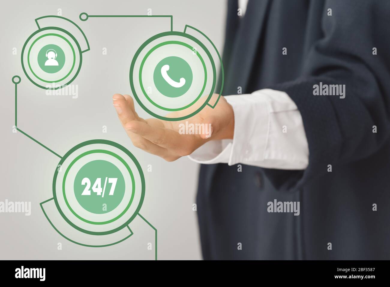 Technical support agent with digital icons on grey background, closeup Stock Photo