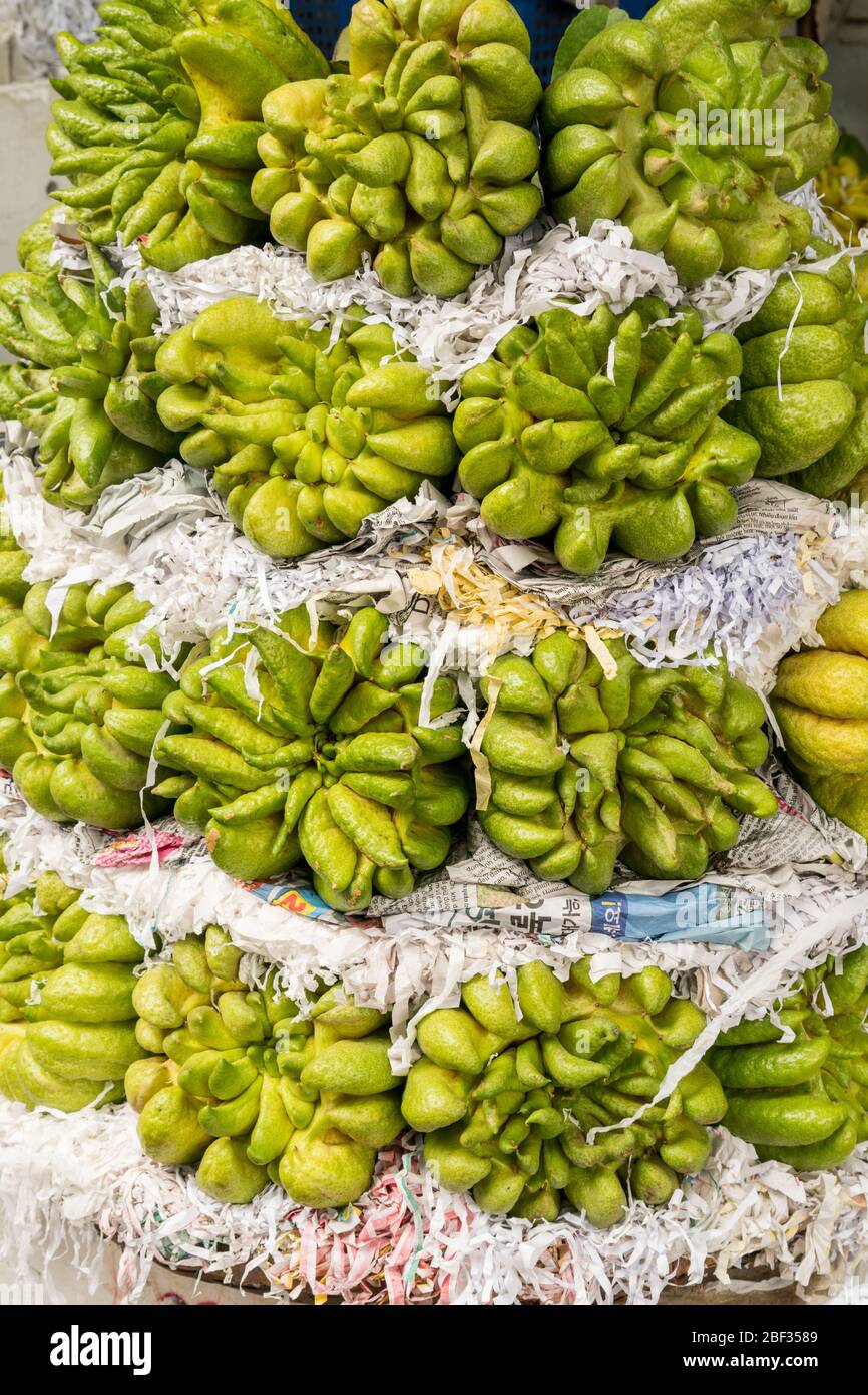 Buddha's Palm fruit in a produce stall at Dong Xuan Market, Hanoi, Vietnam Stock Photo