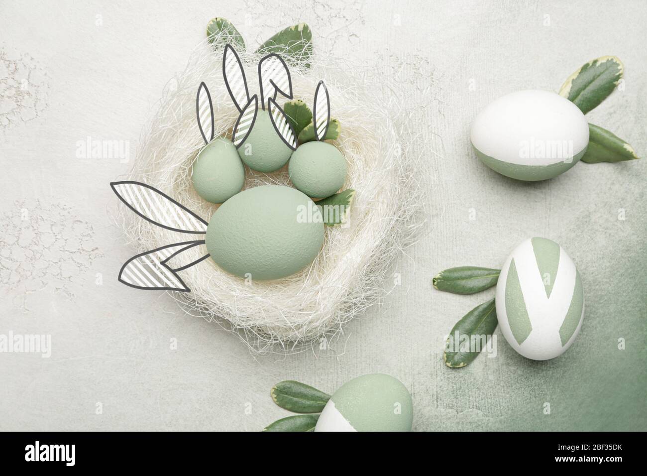 Beautiful Easter eggs with drawn bunny ears on color background Stock Photo