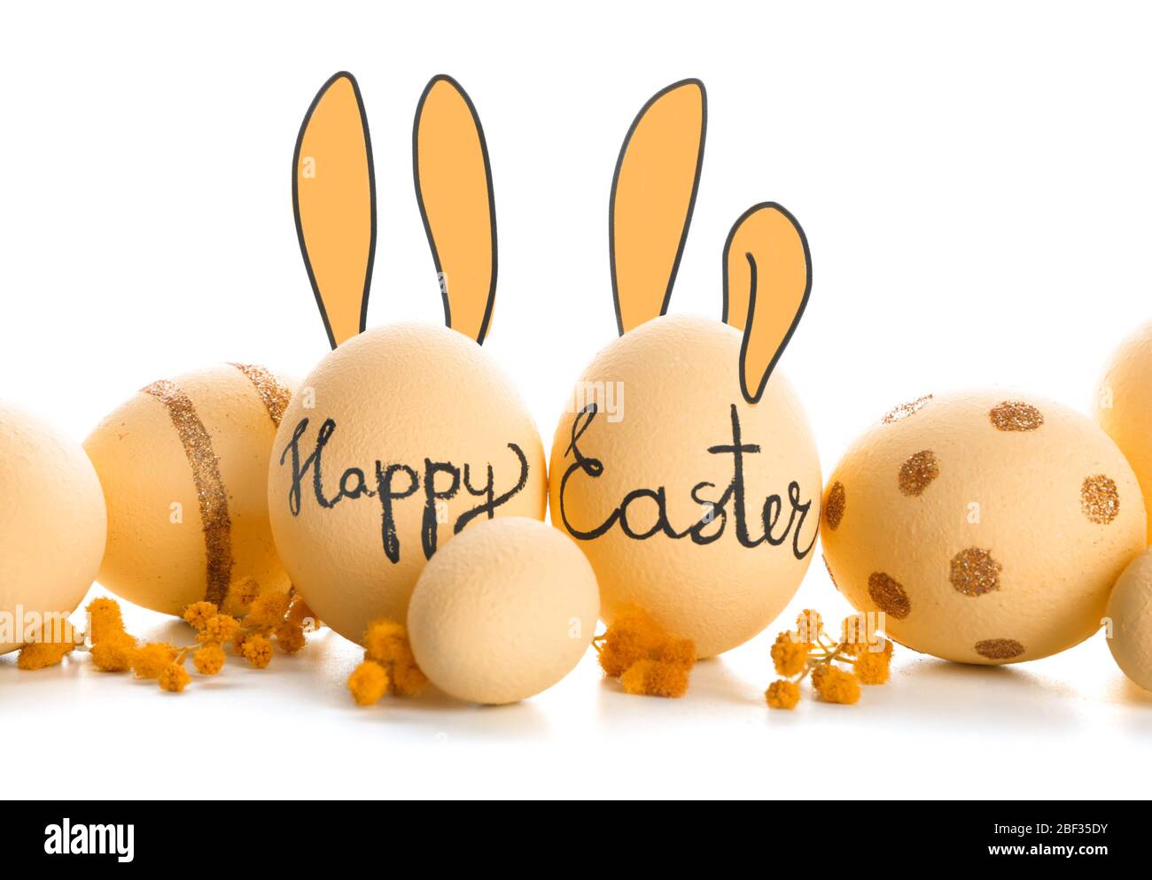 Beautiful Easter eggs with drawn bunny ears on white background Stock Photo