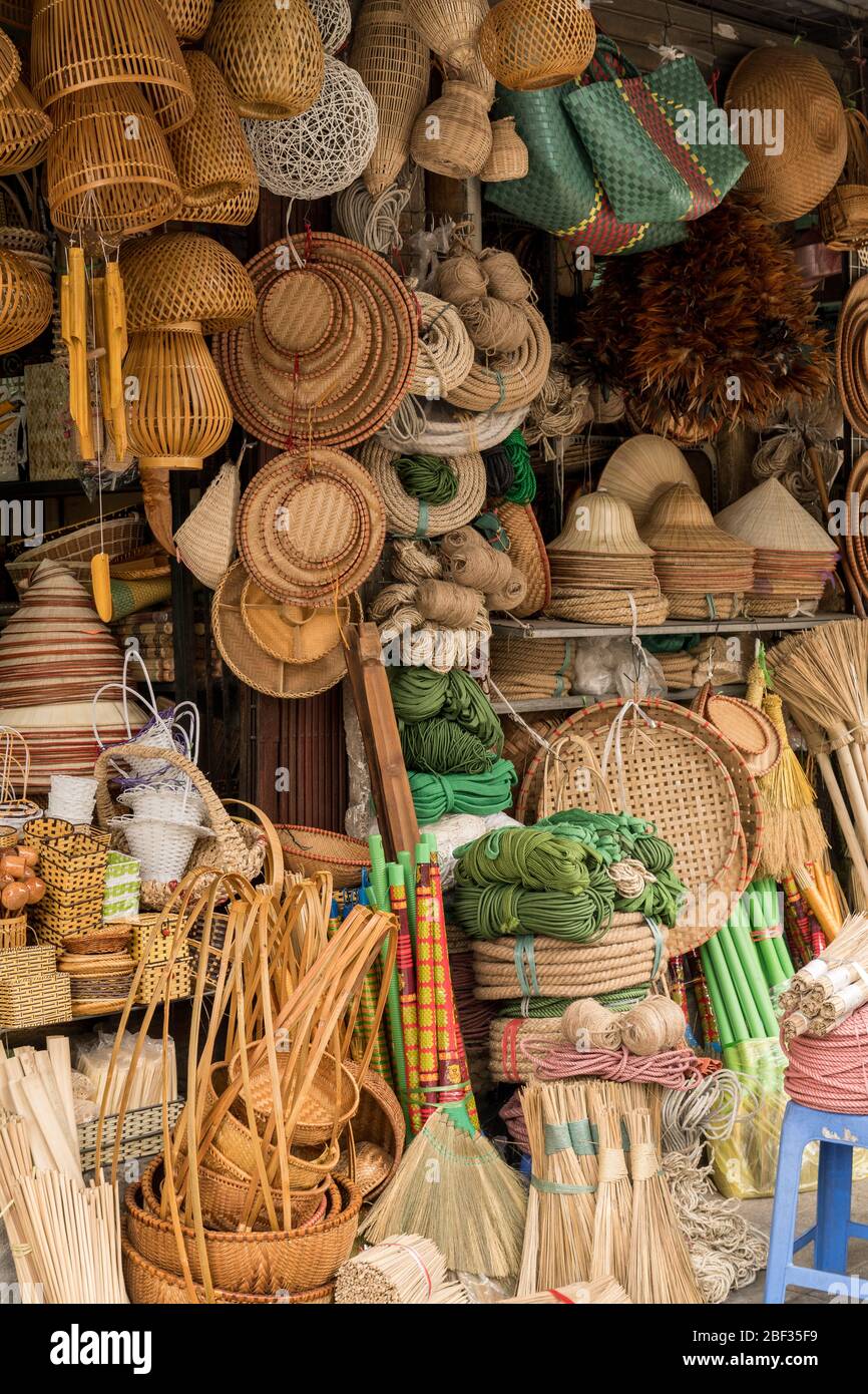 Brooms, baskets and hats for sale at a stall in the Dong Xuan Market, Hanoi, Vietnam Stock Photo