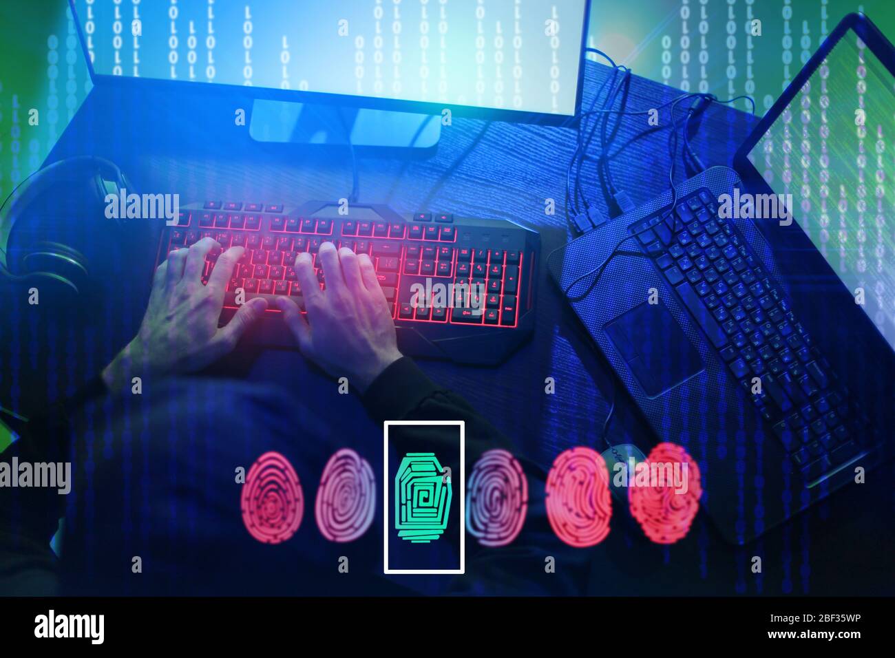 Professional hacker using computer in dark room Stock Photo