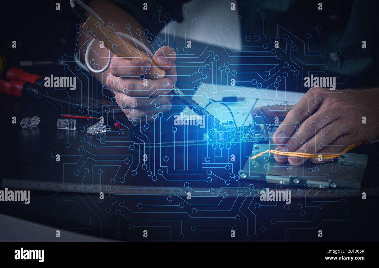 Electronic technician working in service center Stock Photo