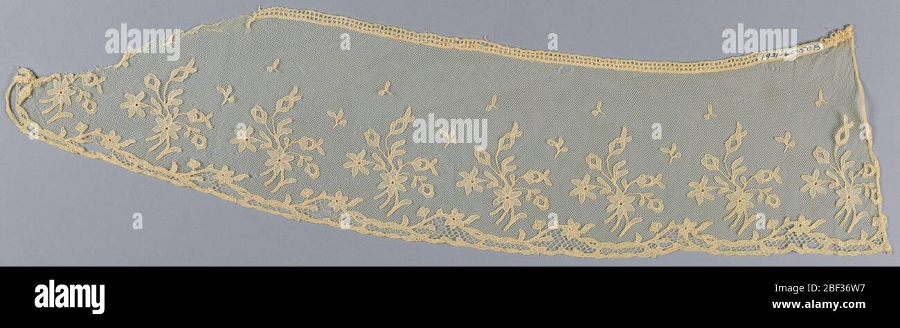 Edging. White imitation Carrickmacross; pattern of floral sprays cut in muslin and applied to machine net; one ornamental edge. Stock Photo