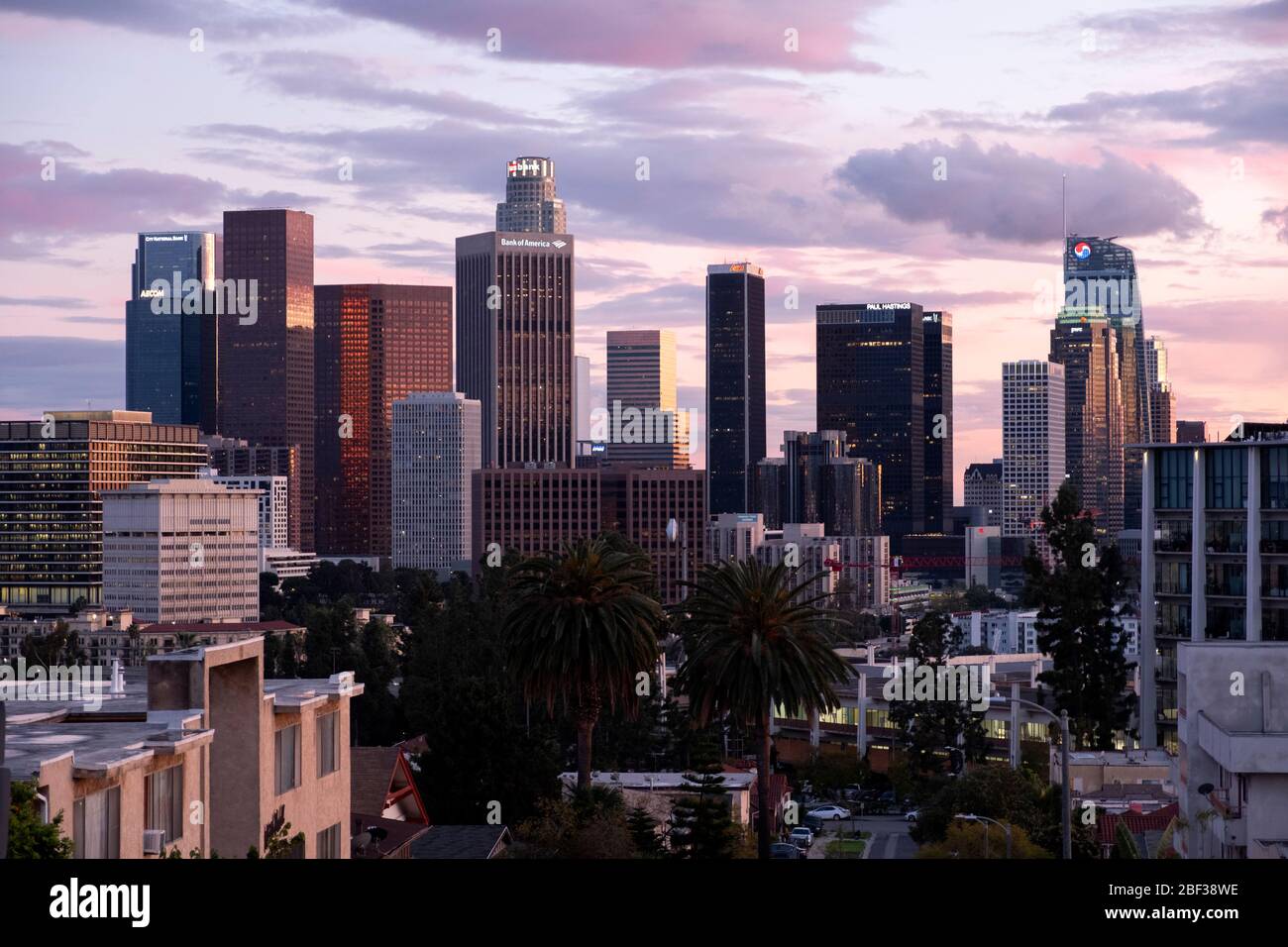 Skyline of Los Angeles at sunset with colorful pink and golden clouds in the sky as viewed from Angelino Heights neighborhood Stock Photo