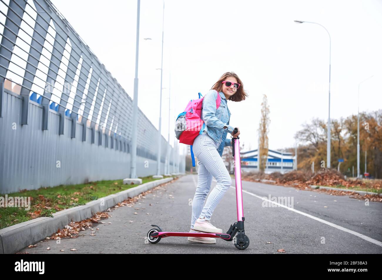 Teenage girl riding kick scooter outdoors Stock Photo Alamy