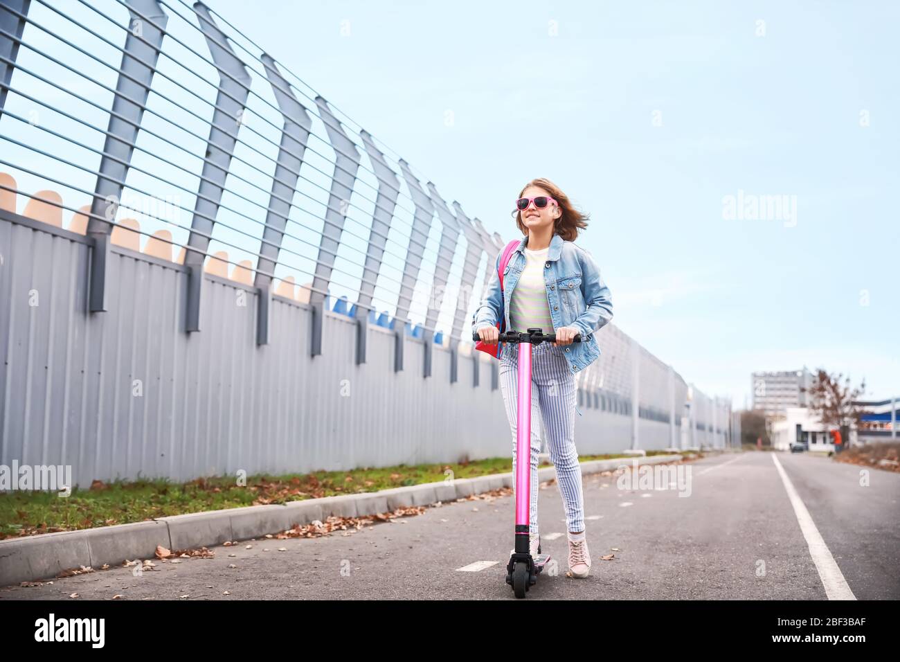 Teenage girl riding kick scooter outdoors Stock Photo Alamy