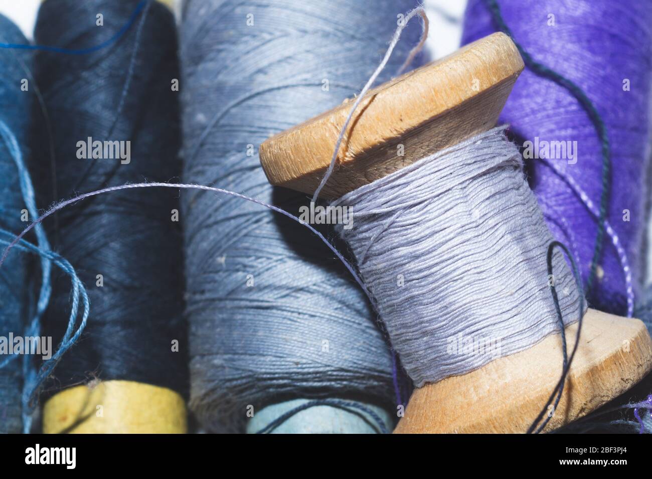 Tangled threads for sewing. different spools of thread Stock Photo Alamy