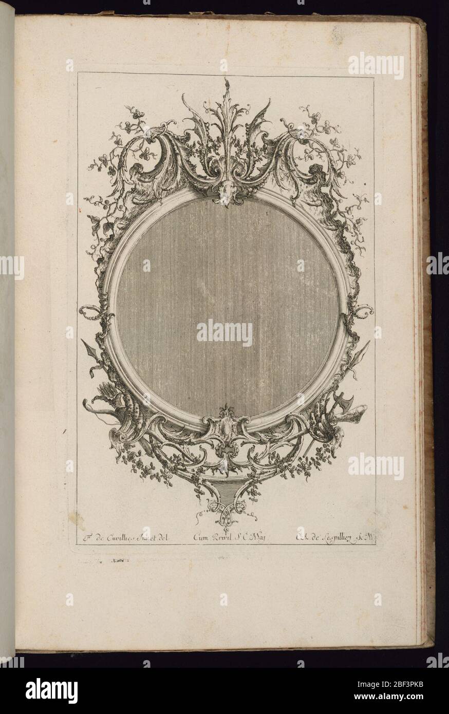 Frame with Two Scrolls of Leaves Troisime Livre de Cadres Third Book of Frames. Upright frame design for a mirror or painting, circular form, topped by two scrolls of leaves. Weaponhs at lower left and right, vegetal decoration throughout. Stock Photo