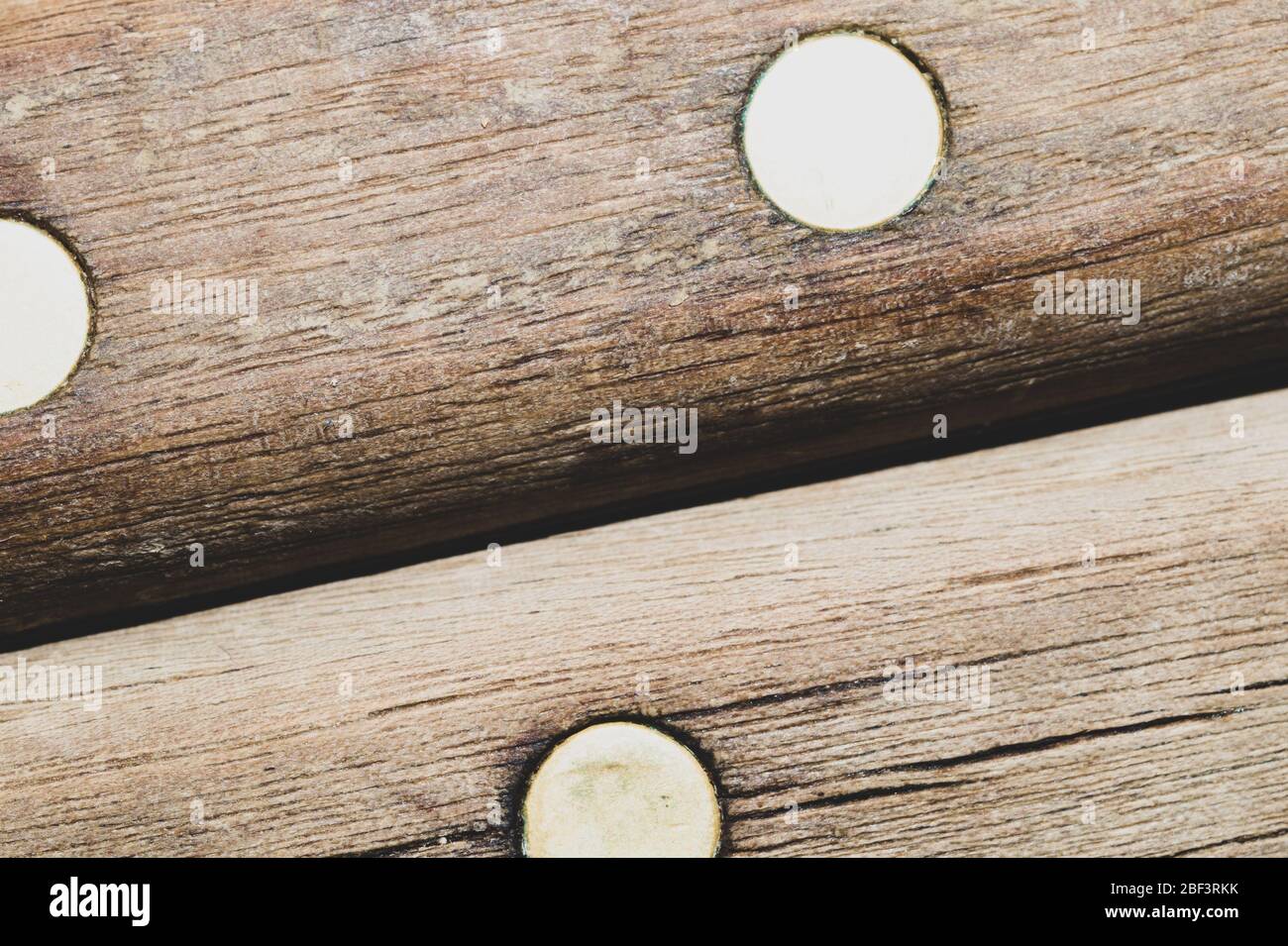 Old wooden background with dowels. wood texture with a metal pins Stock Photo