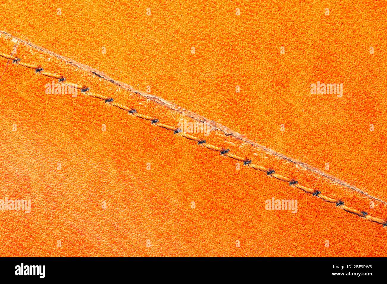 Brown leather texture with a linear stitch. material with seam Stock Photo