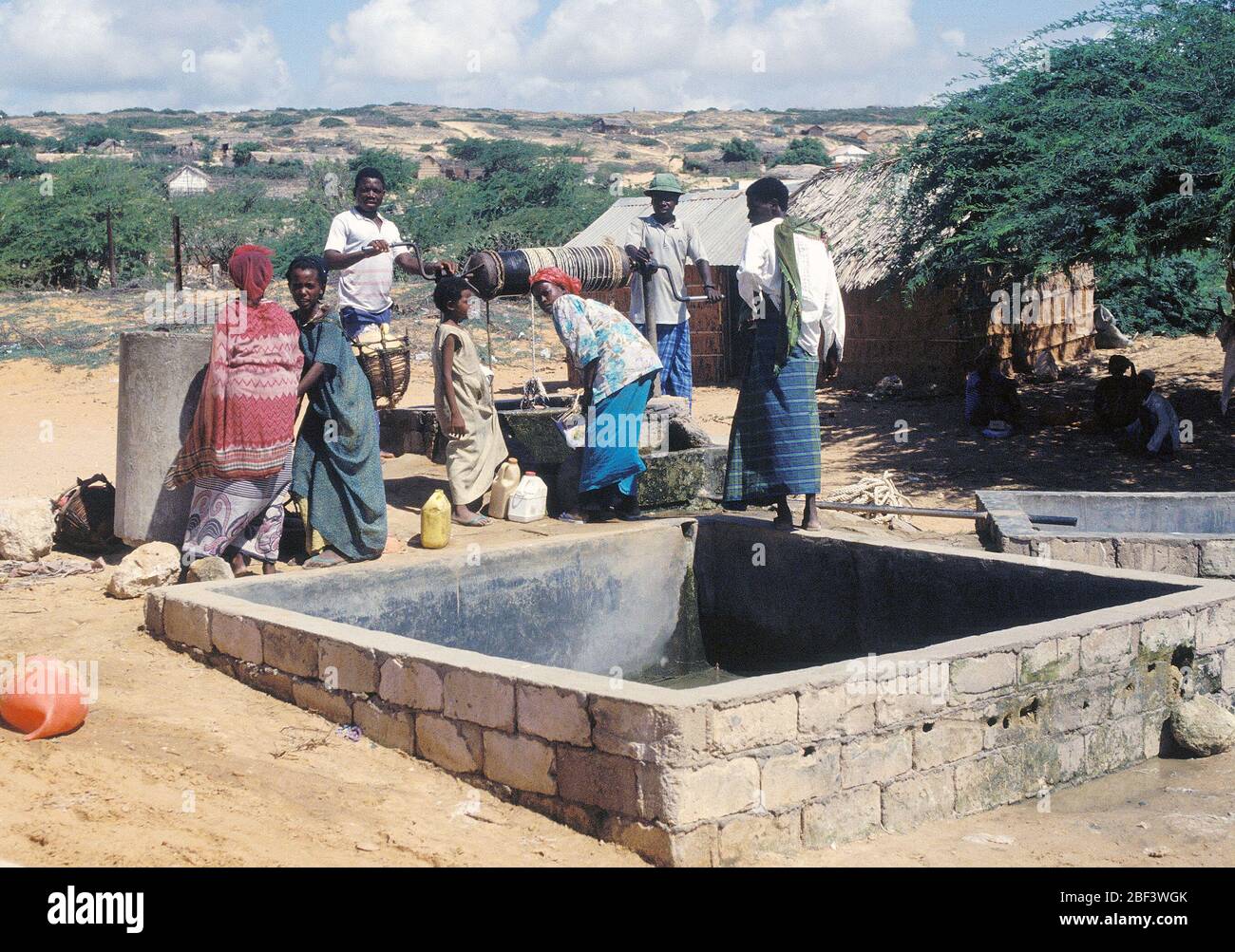 1993 - Somalis gather to draw from a well in the village.  The Moroccan Army maintains a base in Marka (Merca) Somalia Stock Photo