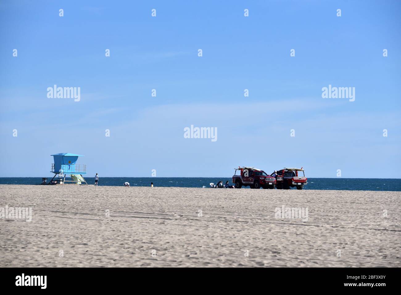 HUNTINGTON BEACH, CA/USA - Lifeguard hut and vehicles on the beach Stock Photo