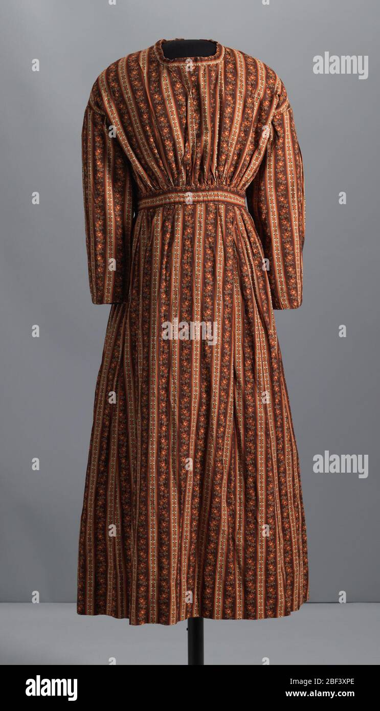 Dress made by an unidentified enslaved woman or women. This is a handstitched long-sleeved dress with a full skirt made from a balanced plain-weave printed cotton. The sleeves are gathered at the back shoulder seam and the shoulder seam is dropped in the back. Stock Photo
