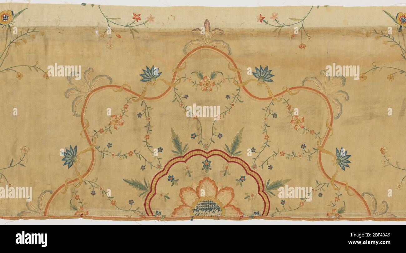 Panel fragment. Fragment from the center of the panel in ivory-colored silk satin embroidered in polychrome silks to form a central medallion of large-size flowers framed by ribbons and flowering vines in a field of meandering vines. Stock Photo