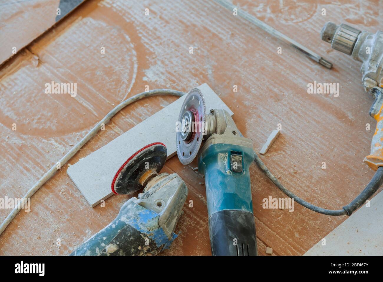 tiler tool angle grinder and ceramic tile on a floor Stock Photo Alamy
