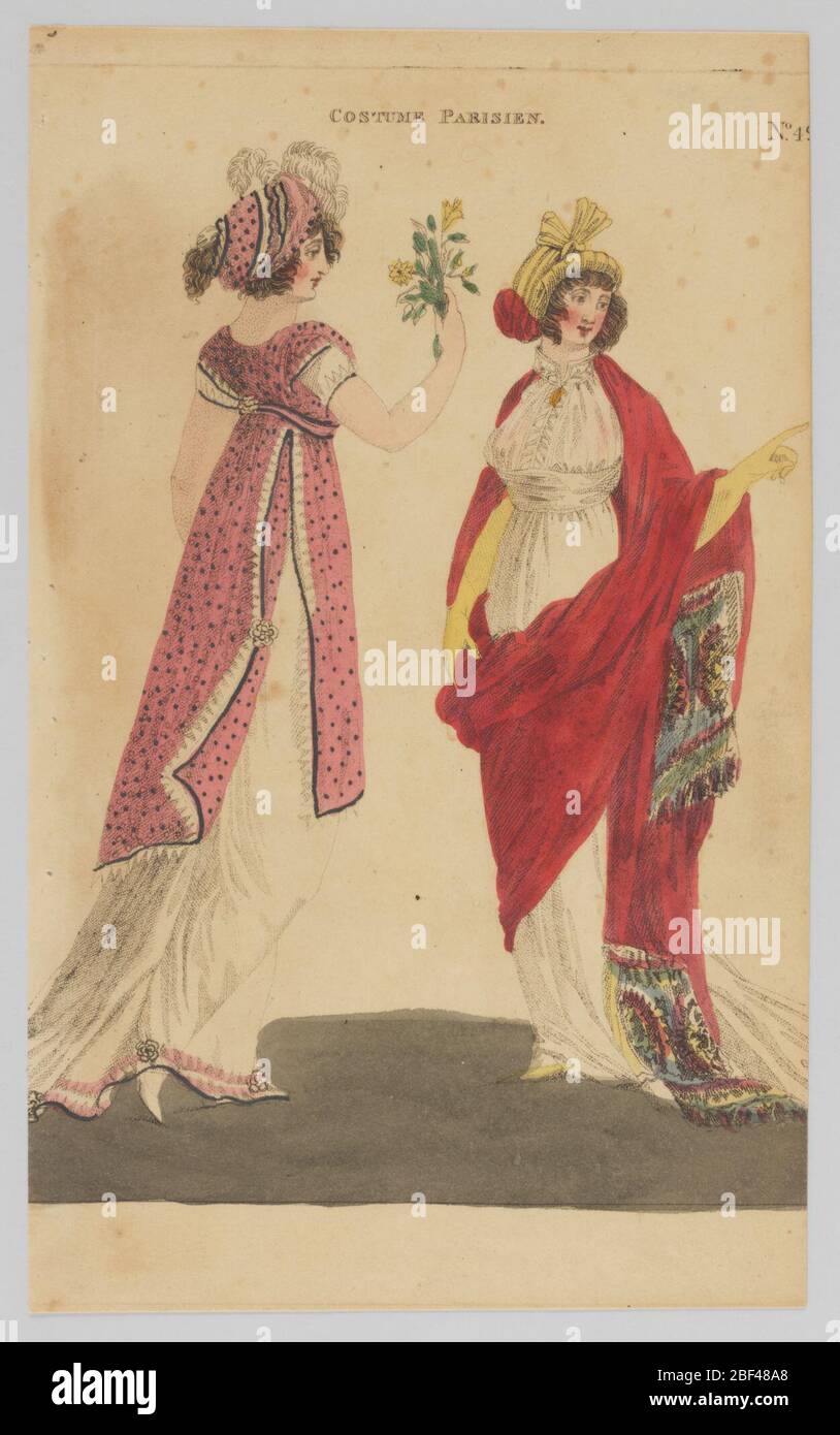Plate 49 Costume Parisien Parisian Costume Magazine of Female Fashion of London and Paris. Fashion illustration featuring a woman on the left in a floor-length dress that includes a long, white skirt and a knee-length top layer that opens and features black dots against a pink background. Stock Photo