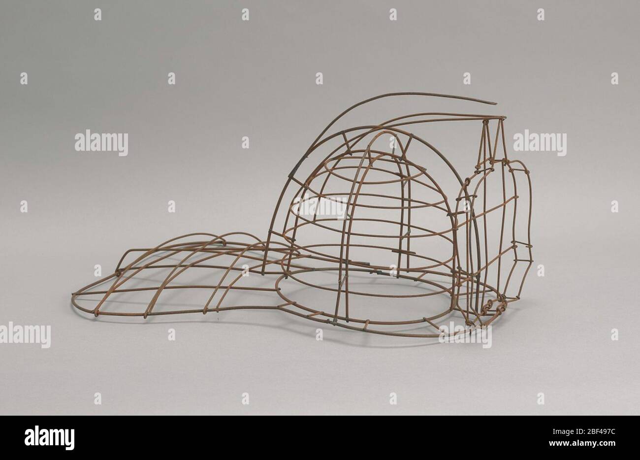 Wire frame firemans helmet. Frame designs which honored the professional life of the deceased were a popular option for the late-nineteenth and early-twentieth-century funeral. Vehicles, tools, and products were recreated in flowers to celebrate a loved one’s life’s work. Stock Photo