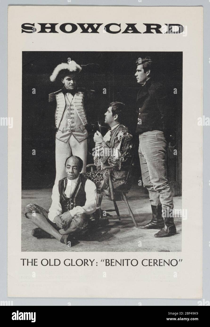Theatre program for The Old Glory Benito Cereno. Showcard for The Old Glory: 'Benito Cereno'. White background with black lettering; black and white photograph at center featuring five men in costume; two men are standing wearing military uniforms, one man sits in a wooden chair, while the last man sits on the floor. Stock Photo