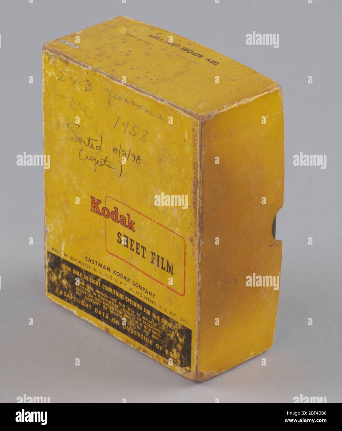 Film box from the studio of HC Anderson. An empty Kodak Safety Film Tri-X Panchromatic Sheet Film box, gold with red and black text. Handwriting at top reads, 'Sorted 8/3/98 | (Rejects),' other handwriting has faded to be illegible Stock Photo