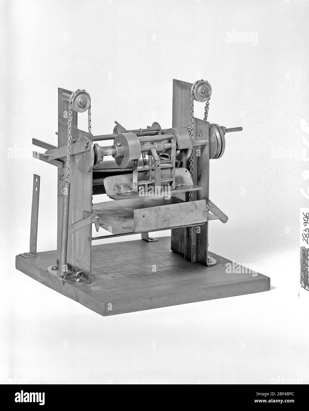 Patent Model of a Sheetfeeding Machine. This patent model demonstrates an invention for a sheet feeder for 'printing-presses, ruling-machines, paper box and bag machines, and analagous machines.” The invention was granted patent number 283906.Currently not on view Stock Photo