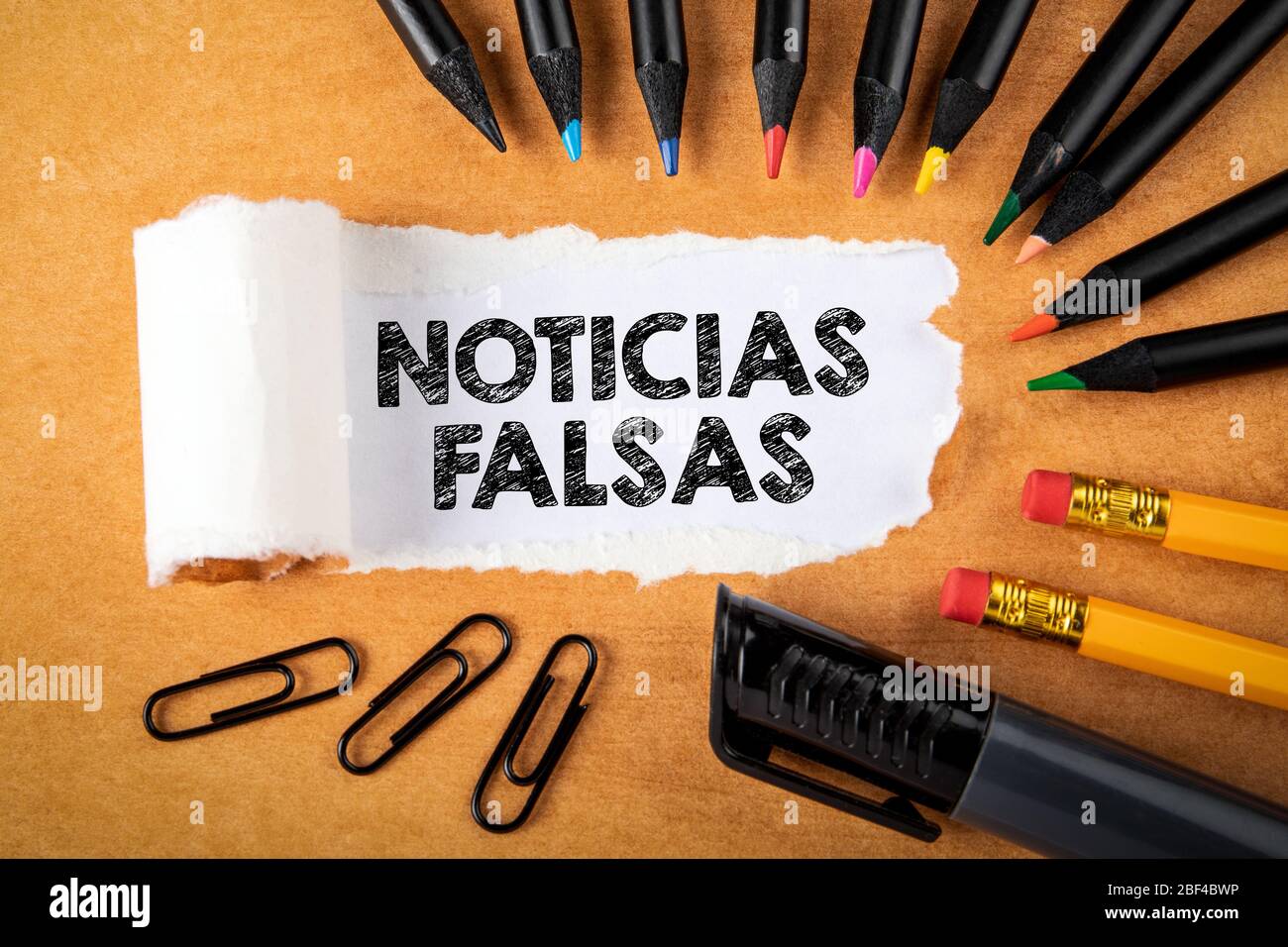 Noticias falsas Means Fake News in Spanish. Panic, money fraud and politics concept. Text under torn paper Stock Photo