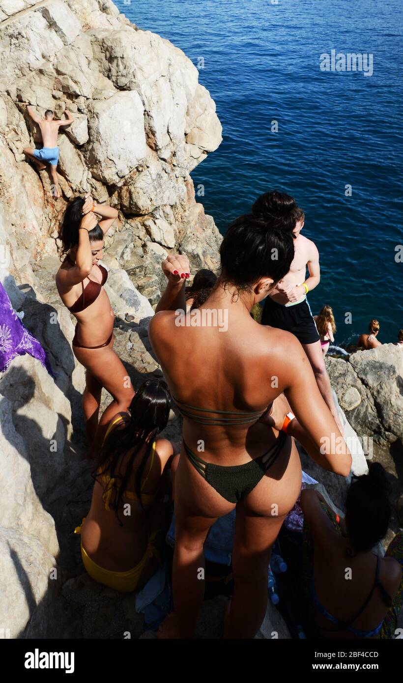 Bikini vibes - Tourist enjoying the sun and the Adriatic sea in Dubrovnik, Croatia. Stock Photo