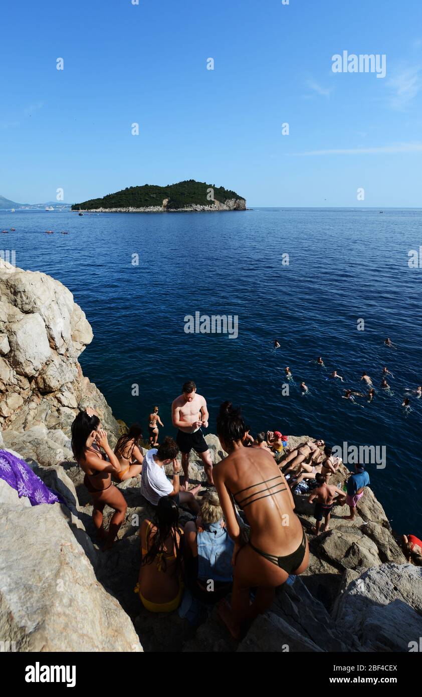 Bikini vibes - Tourist enjoying the sun and the Adriatic sea in Dubrovnik, Croatia. Stock Photo