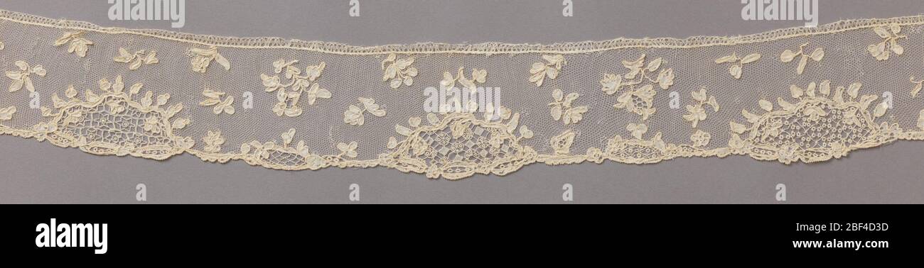 Edge. Band of Point d'Alençon worked with scattered sprays of flowers. Irregular edge of rococo design. Stock Photo